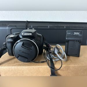 Canon Powershot SX50HS with case, neck strap, usb cable, battery, and charger